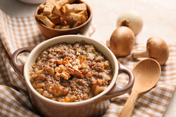 Pot of tasty lentils soup on table