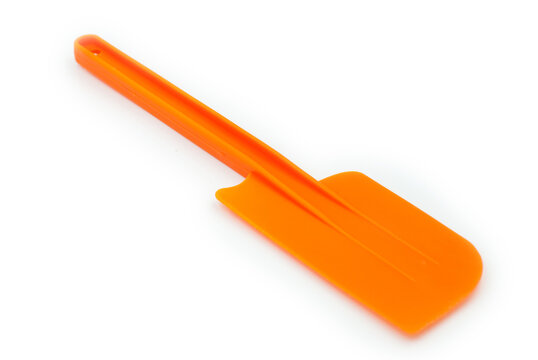 Orange plastic spatula on a white background