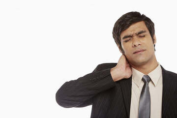 Businessman touching his neck
