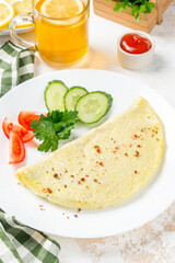 Fototapeta na wymiar Breakfast omelet with vegetables on a white, round plate