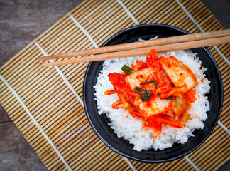 Korean food, top view kimchi with a rice in bowl tasty yummy and spicy on wood table background for healthy. 