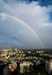 potrait shot of rainbow in india ,maharashtra in mumbai city near gorai beach with golden temple pagoda in the frame