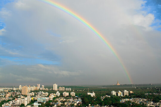 rainbow in india ,maharashtra in mumbai near gorai beach with golden temple pagoda in the frame