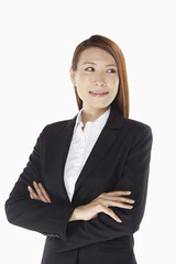 Businesswoman smiling with arms crossed