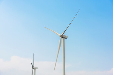 Fototapeta premium Wind turbines for electric power production. Green ecological power energy generation.