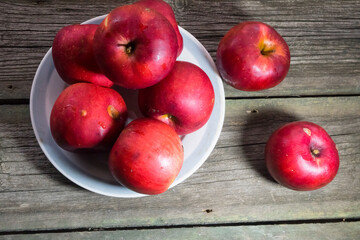 Red apples on wooden background. Copy space.