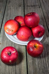 Red apples on wooden background. Copy space.