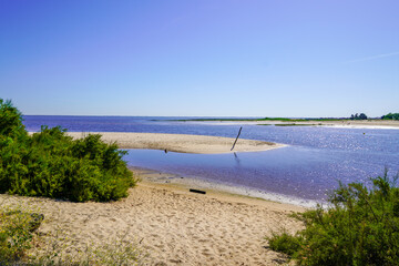 Fototapeta na wymiar sand beach and blue summer sky at Ares basin in Arcachon Bay Gironde France