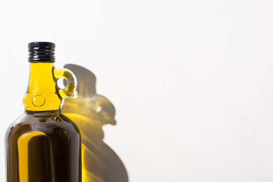 Top View Of Olive Oil In Bottle On White Background