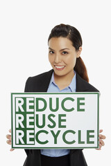 Businesswoman smiling and holding up a placard