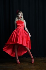 young and beautiful girl tries on her first evening red dress