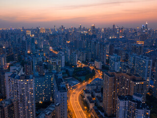 Aerial shot of the traffic through skyscrapers in Shanghai, China, shot at sunset.