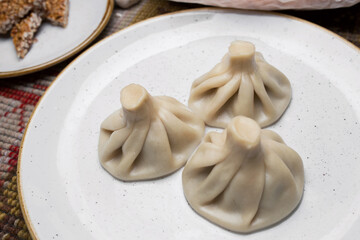 Georgian Khinkali on a white plate. Closeup. view from above. National cuisine