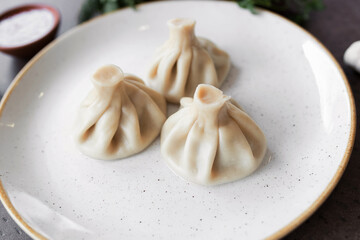 Georgian Khinkali on a white plate. Closeup. view from above. National cuisine
