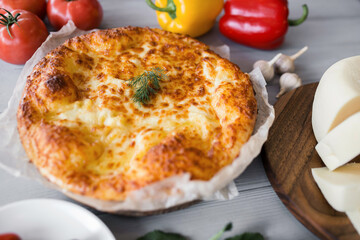 Georgian pita close-up. vegetables and fruits around. Gray background
