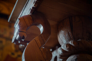 The interior of a wooden Russian temple. Table stand in the form of a wooden carved horse.