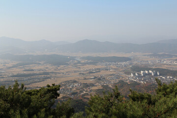 Fototapeta na wymiar Gyeongju landscape with the buildings, mountains and paddy fields in autumn from Mt. Tohamsan, South Korea