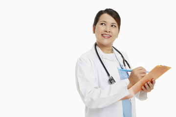 Fototapeta premium Medical personnel writing down notes on clip board