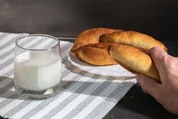 Man holds pie in his hand. simple country food.