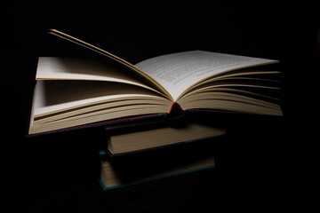 stack of books with an open book on top