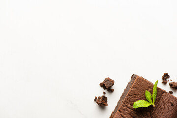 top view of delicious brownie piece with mint on white background