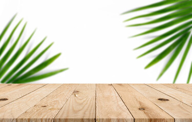 Empty top wooden table with blurred green leaf on concrete wall background