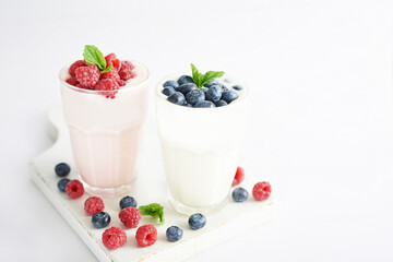 Yogurt cocktail and parfait. Natural detox. Liquid ice cream. Healthy food and breakfast. Good morning. Berry Milk Smoothie with blueberries, strawberries, raspberries. Fresh diet dessert. Summer card