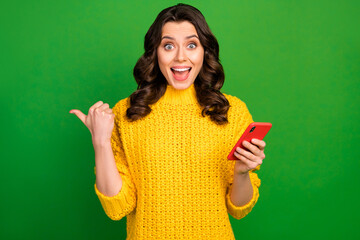 Surprised crazy girl use cell phone point forefinger copyspace present incredible online adverts promotion wear style stylish trendy jumper sweater isolated bright shine color background