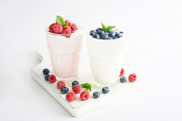 Yogurt cocktail and parfait. Natural detox. Liquid ice cream. Healthy food and breakfast. Good morning. Berry Milk Smoothie with blueberries, strawberries, raspberries. Fresh diet dessert. Summer card
