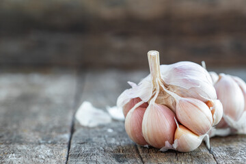 Dried garlic cloves on old wooden table.