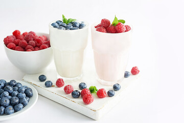 Yogurt cocktail and parfait. Natural detox. Liquid ice cream. Healthy food and breakfast. Good morning. Berry Milk Smoothie with blueberries, strawberries, raspberries. Fresh diet dessert. Summer card