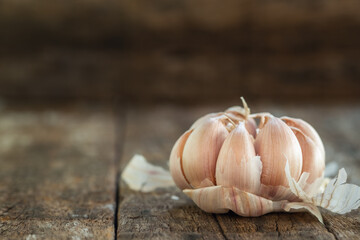 Dried garlic cloves on old wooden table.