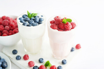 Yogurt cocktail and parfait. Natural detox. Liquid ice cream. Healthy food and breakfast. Good morning. Berry Milk Smoothie with blueberries, strawberries, raspberries. Fresh diet dessert. Summer card
