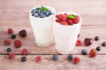 Yogurt cocktail and parfait. Natural detox. Liquid ice cream. Healthy food and breakfast. Good morning. Berry Milk Smoothie with blueberries, strawberries, raspberries. Fresh diet dessert. Summer card