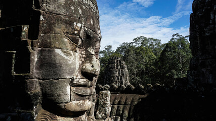Detail of face carved in stone at the Bayon temple in Cambodia