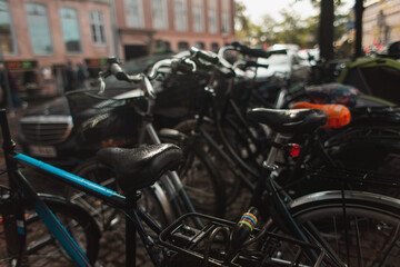 Selective focus of wet bicycles on urban street in Copenhagen, Denmark