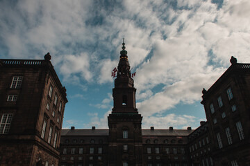 Obraz premium Low angle view of danish flags of facade of Christiansborg Palace in Copenhagen, Denmark