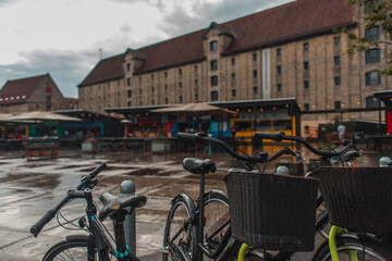 Selective focus of bicycles on urban street during rain in Copenhagen, Denmark