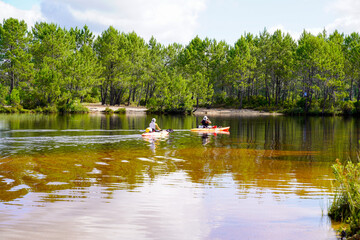 Fototapeta na wymiar men in plastic recreational kayaks enjoy in lake beach of Lacanau