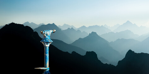 Public binoculars and Mountain Silhouettes at Sunrise. Foresight and vision for new business concepts and creative ideas. Alps, Allgau, Bavaria, Germany. - obrazy, fototapety, plakaty