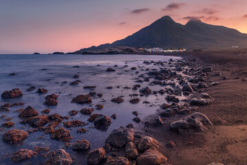 Puesta de sol sobre el cerro de Los Frailes en la playa de Los Escullos, Parque Natural del Cabo de...