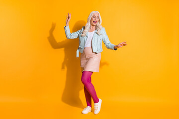 Full length photo of positive cheerful elegant old lady enjoy weekend discotheque dancing wear pink good look pantyhose isolated over bright color background
