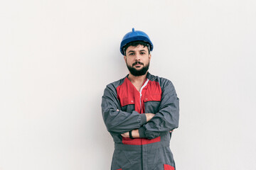 Construction worker portrait on white wall posing
