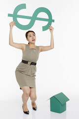 Woman lifting up a dollar sign