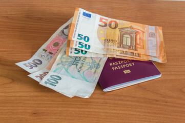 Euro (EUR) and Czech koruna banknotes (CZK) on biometric passport.
