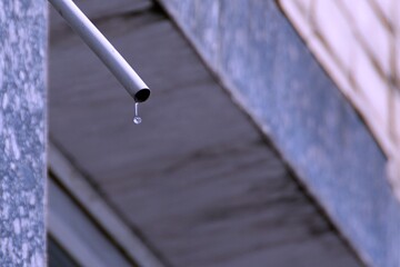 drop is hanging on pipe of air conditioner