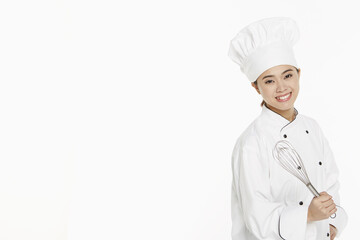 Female chef holding a wire whisk