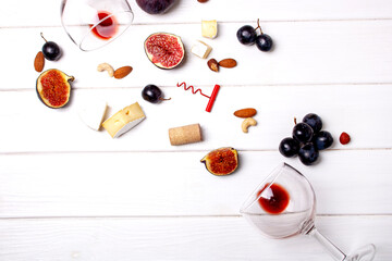 Naklejka na ściany i meble Two glasses of wine, grapes, figs and a corkscrew. Flat Lay Style