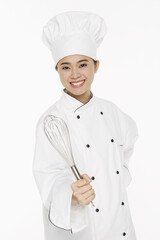 Female chef holding a wire whisk