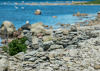 Fototapeta premium beautiful white stone piles by the sea, these objects were built by travelers, Saaremaa Island, Estonia